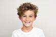 © Nico Vincentini - A close-up portrait photo of a charming young boy smiling, showcasing his clean teeth, designed for a dental advertisement. The boy features modern, stylish hair. Isolated on a white background.GenAI