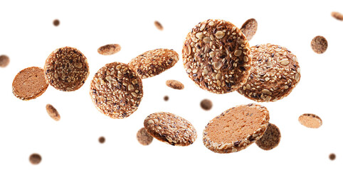 Oatmeal cookies sprinkled with seeds fly and levitate in space. Selective focus, isolated on white