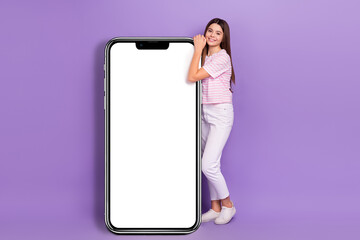 Sticker - Full size photo of charming schoolgirl showing huge empty space telephone isolated on violet color background