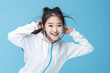 © wolfhound911 - Pretty asian school girl in sports clothing doing some fun dance moves