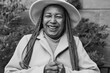 Happy african senior woman smiling in fornt of camera during winter time - Black and white editing