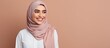 Confident young Arab woman in hijab pointing in different directions for an advertisement