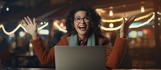 Aufkleber - An enthusiastic middle aged woman working on her laptop at night happily pointing to the side with open palms to display a copy space for advertising purp