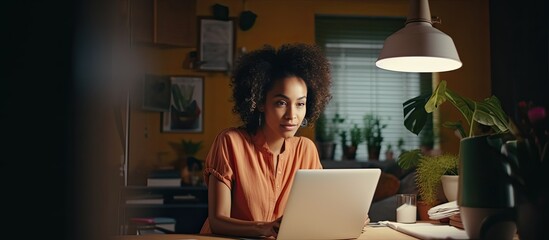 Leinwandbilder - Biracial woman working remotely from home using laptop for business