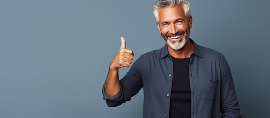 Canvas Print - Content middle aged man happily points to empty area while smiling confidently