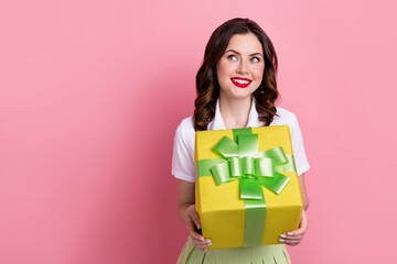 Poster - Photo of sweet dreamy woman dressed white shirt holding present box looking empty space isolated pink color background