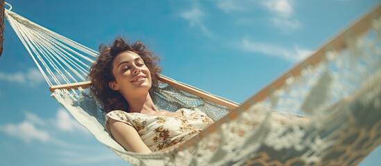Poster - Blue sky beach relaxation holiday concept with woman in hammock