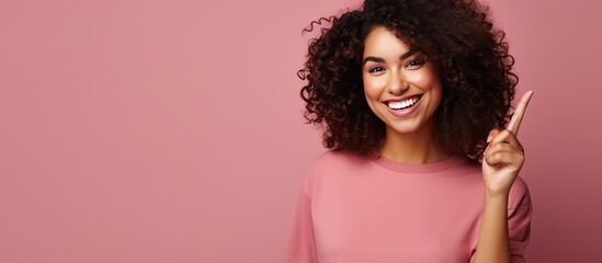 Poster - Smiling cheerful Hispanic woman pointing upwards with object in space
