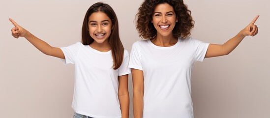 Aufkleber - Excited Hispanic mother and daughter smiling pointing with open palms showing copy space
