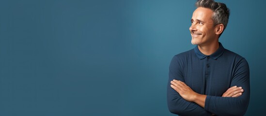 Poster - A mature and confident man feeling joyful and optimistic gazes up with arms crossed