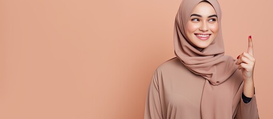 Poster - Confident young Arab woman in hijab pointing in different directions for an advertisement