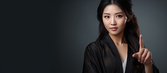 Aufkleber - Young Asian woman in bathrobe pointing to empty copy space showcasing beauty