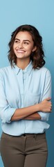 Poster - Casually dressed woman on blue background smiling and presenting blank copy space