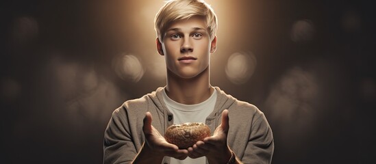 Poster - Young adult man with blond hair holding an object and presenting it on a blank background
