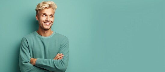 Poster - Happy and satisfied young man casually pointing to empty space with a cheerful smile