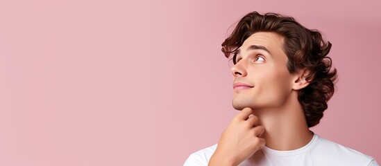 Poster - Young white man on pink background holds space on hand amazed and happy