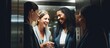© HN Works - Multiracial businesswomen discussing in elevator celebrating convenience