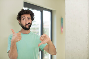 Wall Mural - young crazy bearded man feeling confused, clueless and unsure, weighting the good and bad in different options or choices