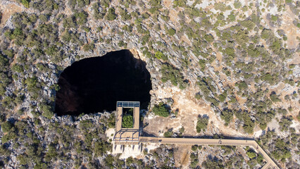 Heaven and hell (Cennet and Cehennem) are two large sinkholes, There is a chapel in paradise cave. Aerial view drone shooting, Mersin Province, Turkey