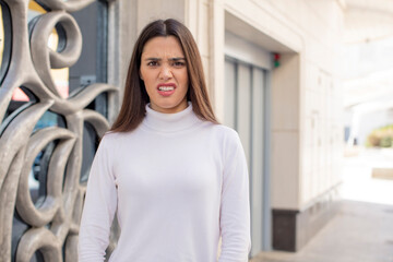 Wall Mural - pretty young adult woman feeling terrified and shocked, with mouth wide open in surprise