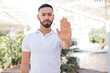 © kues1 - young handsome man looking serious, stern, displeased and angry showing open palm making stop gesture