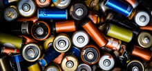 A colorful assortment of batteries. A pile of batteries that are all different colors