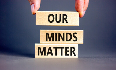 Our minds matter ourmindsmatter symbol. Concept words Our minds matter on wooden block. Beautiful grey table grey background. Businessman hand. Our minds matter ourmindsmatter concept. Copy space.