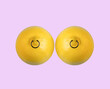 Lemons in shape of woman breast with nipple piercing on pink background.