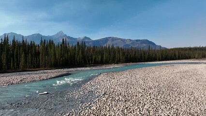 Wall Mural - canada. a drone view of the river in the mountains valley. an aerial view of a forest. winding river