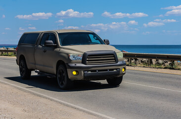 Wall Mural - Pickup truck moves along the road