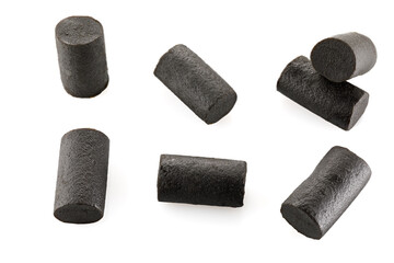 Dark sweet and salt licorice candies. Black licorice chunks isolated on white background. Close-up