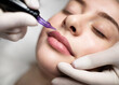 PMU Concept. Permanent Makeup Artist Doing Lip Blushing Procedure To Young Woman
