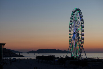 Wall Mural - Ferrywheel on the Promenade Robert Laffont in Marseille at dusk