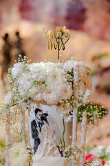 Wall Mural - Close-up of figurine couple on the wedding cake