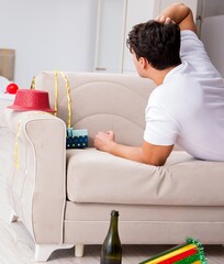 Wall Mural - Man at home after heavy partying