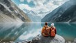 © visoot - Rear view. Travelers couple sitting look at the mountain lake, Adventure and travel in the mountains, Travel concept.
