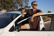 © Marcos - Mature Man taking a break from driving and relaxing and leaning on his car door