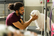 © AntonioDiaz - Adorable pet groomer finishing grooming a maltese dog
