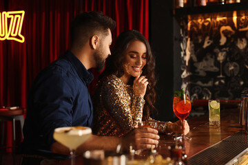 Wall Mural - Lovely couple with fresh cocktails at bar counter