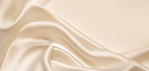 Soft pastel beige cream color, shiny satin silk swirl wave background banner - Abstract textile fabric material, backdrop texture for product display or text