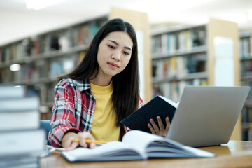 Poster - Young university student using laptop for online learning, searching and learning at library.