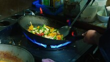 4K Cinematic Cooking Footage Of A Thai Chef Cooking Thai Food In A Wok In A Restaurant Kitchen In Thailand