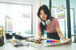 © wattana - Portrait of pretty asian female interior designer in stylish clothes standing at creative office.