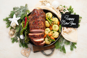 Wall Mural - Roasted sliced Christmas ham on plate with vegetables, festive decoration.