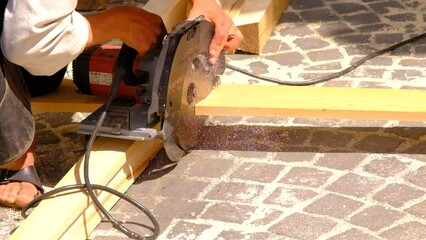 Wall Mural - a man cuts a plank with a circular saw