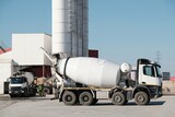 Fototapeta  - White concrete mixers standing by a modern concrete plant.	