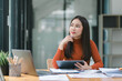 © PRIME STOCK LAB - A businesswoman auditor is conducting an audit of the financial report data of the company, including the balance sheet and income statement, on her computer.