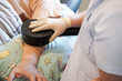 Closeup hands of doctor using electrical muscle stimulation (EMS) on arm elderly patients in nursing homes