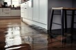 Close up of water leak causing flooded kitchen floor.