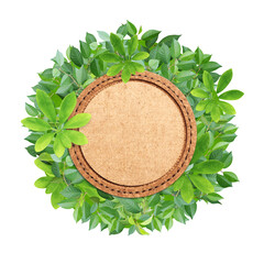 Wall Mural - Responsible consumption. Circle made from green leaves and round  cork label. Eco-friendly business. Love of nature. Ecology and zero waste concept. Isolated on white background